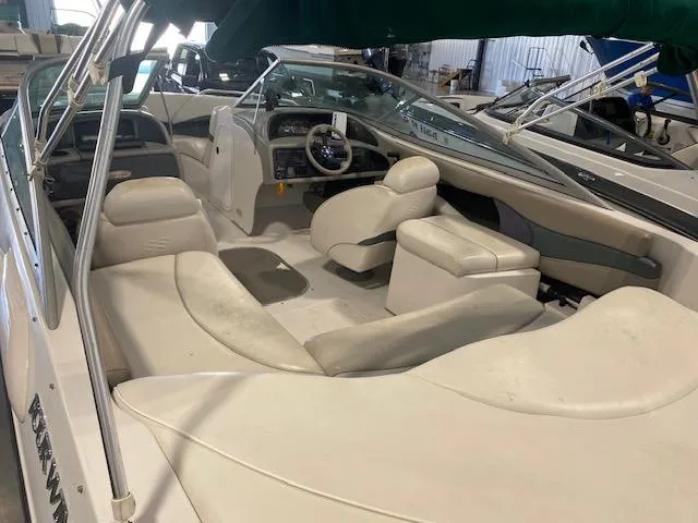 Slide: The Image of 2000 Four Winns 210 Horizon boat interior with white seating and steering console. - 7
