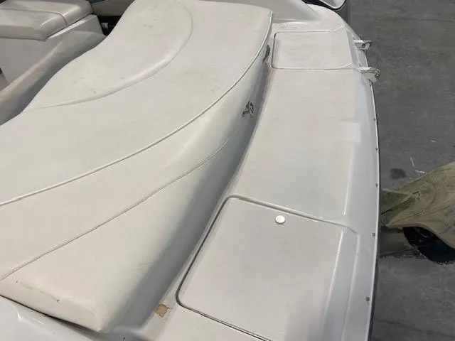 Slide: The Image of 2000 Four Winns 210 Horizon boat interior with white seating and storage compartments. - 8