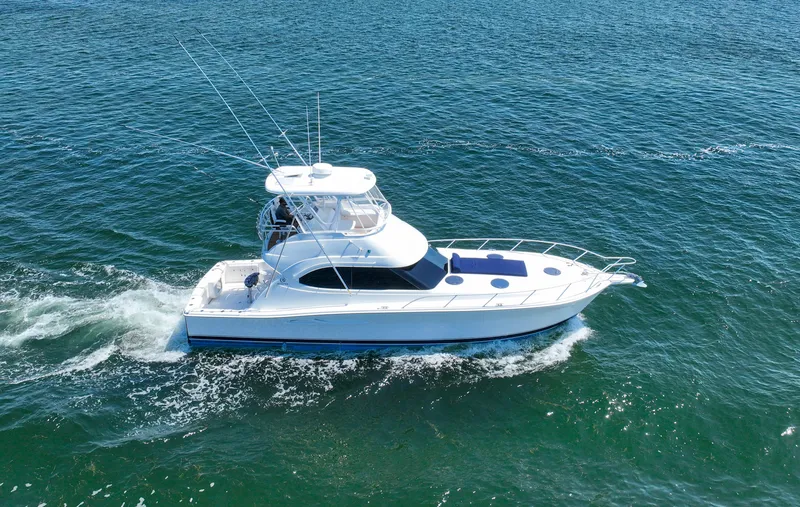 Slide: The Image of 2007 Riviera 42 Flybridge yacht cruising on open water. - 0