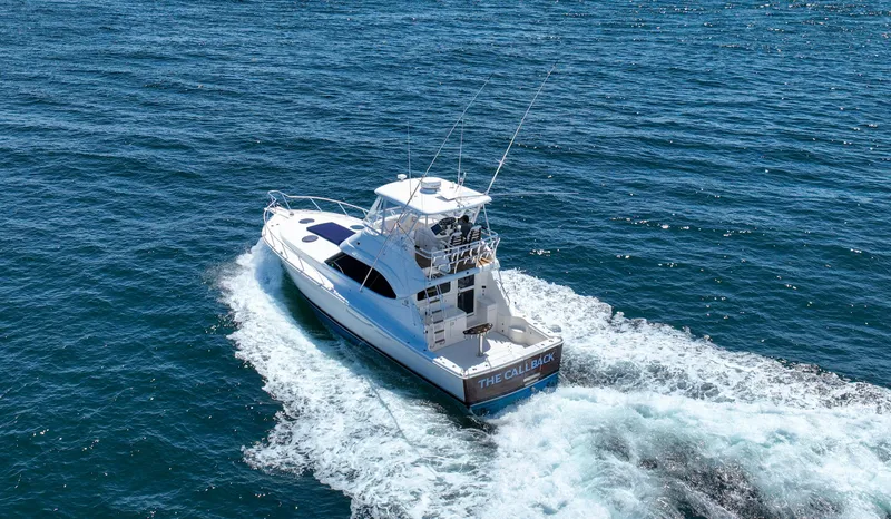 Slide: The Image of 2007 Riviera 42 Flybridge yacht cruising on open water. - 15