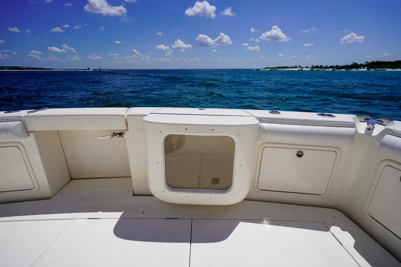 Slide: The Image of 2007 Riviera 42 Flybridge boat deck with ocean view under clear blue sky. - 26