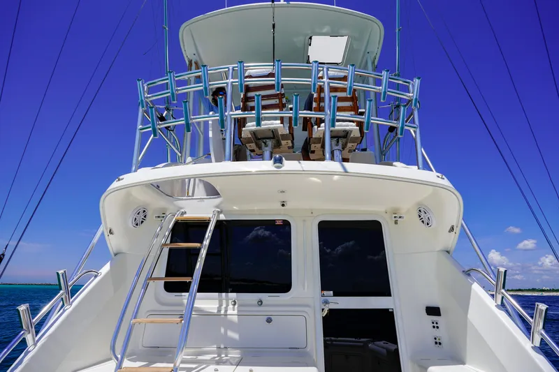 Slide: The Image of 2007 Riviera 42 Flybridge yacht with ladder and blue sky background. - 28
