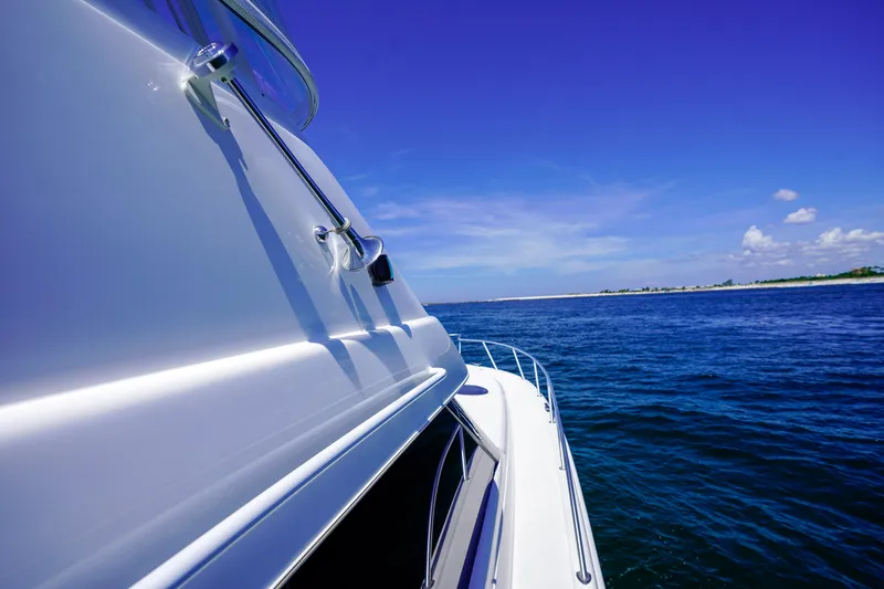 Slide: The Image of 2007 Riviera 42 Flybridge yacht cruising on a clear blue ocean. - 29