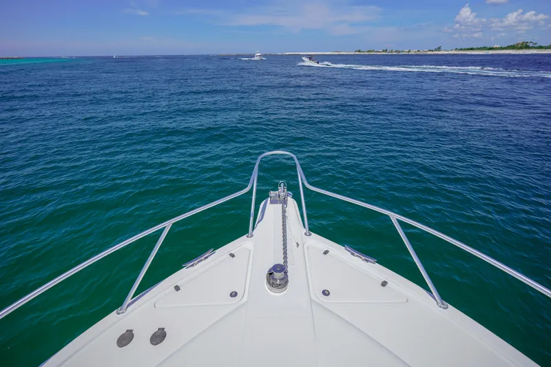 Slide: The Image of Bow view of 2007 Riviera 42 Flybridge yacht cruising on open sea. - 30