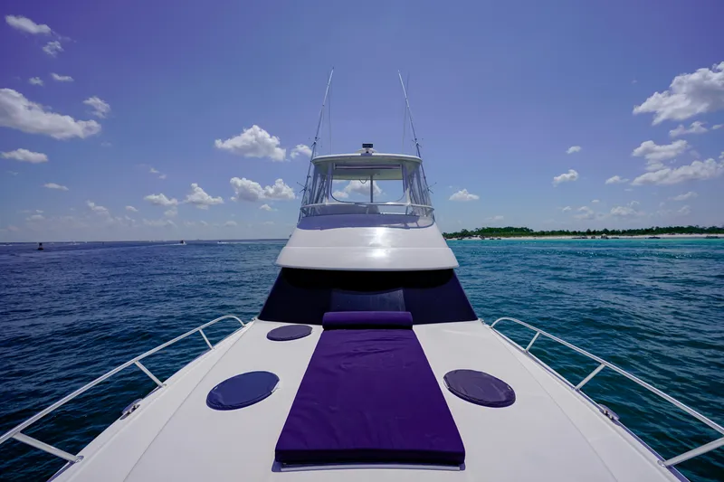 Slide: The Image of 2007 Riviera 42 Flybridge yacht on open sea with clear skies. - 31