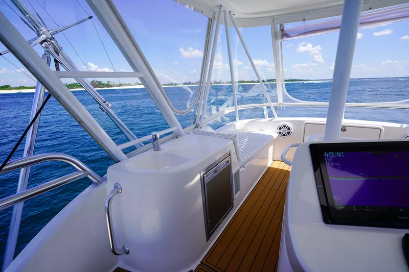 Slide: The Image of 2007 Riviera 42 Flybridge yacht interior with ocean view, featuring navigation equipment and seating. - 36