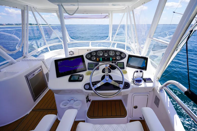Slide: The Image of 2007 Riviera 42 Flybridge helm with modern navigation equipment, overlooking the ocean. - 37
