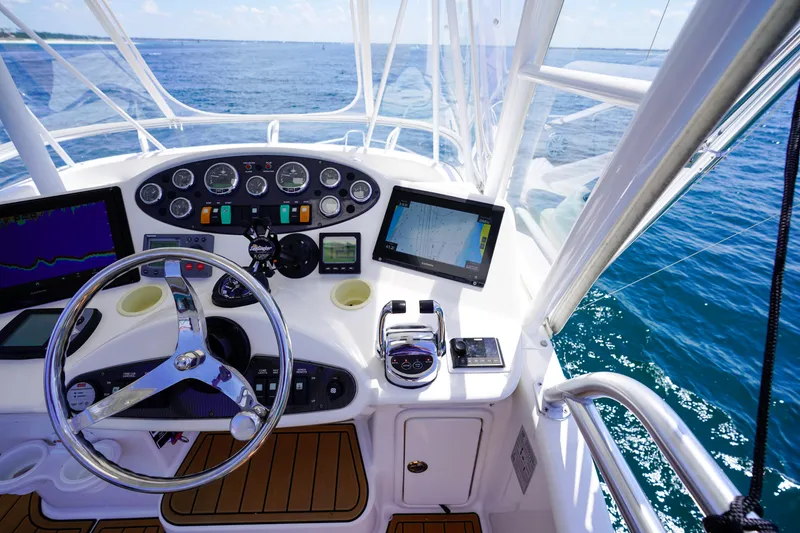 Slide: The Image of 2007 Riviera 42 Flybridge helm with navigation screens and ocean view. - 39