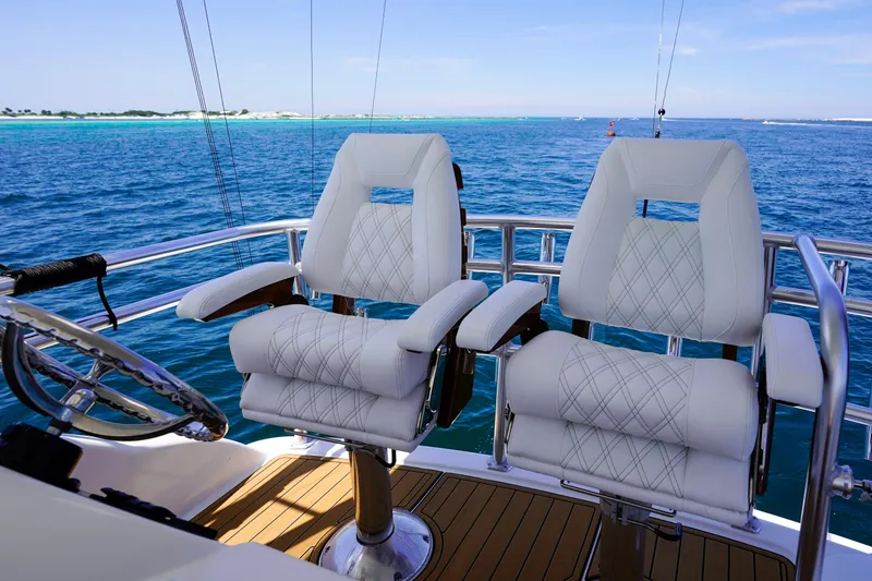 Slide: The Image of Luxury seating on 2007 Riviera 42 Flybridge yacht, overlooking serene ocean waters. - 42