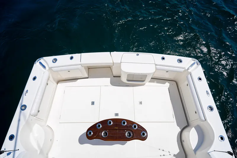 Slide: The Image of 2007 Riviera 42 Flybridge boat deck with seating, rod holders, and ocean view. - 44