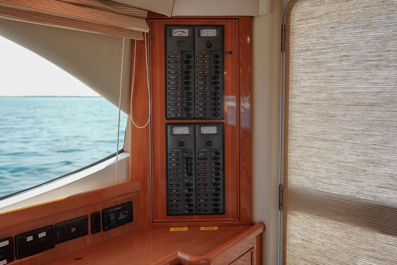 Slide: The Image of Electrical panel inside 2007 Riviera 42 Flybridge yacht, with ocean view through window. - 47