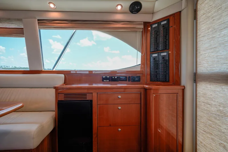 Slide: The Image of Interior of 2007 Riviera 42 Flybridge yacht with wood cabinetry and control panels. - 48