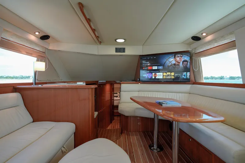 Slide: The Image of Luxurious interior of 2007 Riviera 42 Flybridge yacht with modern entertainment system. - 49