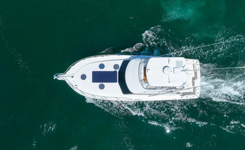 Slide: The Image of Aerial view of 2007 Riviera 42 Flybridge yacht cruising in clear waters. - 8