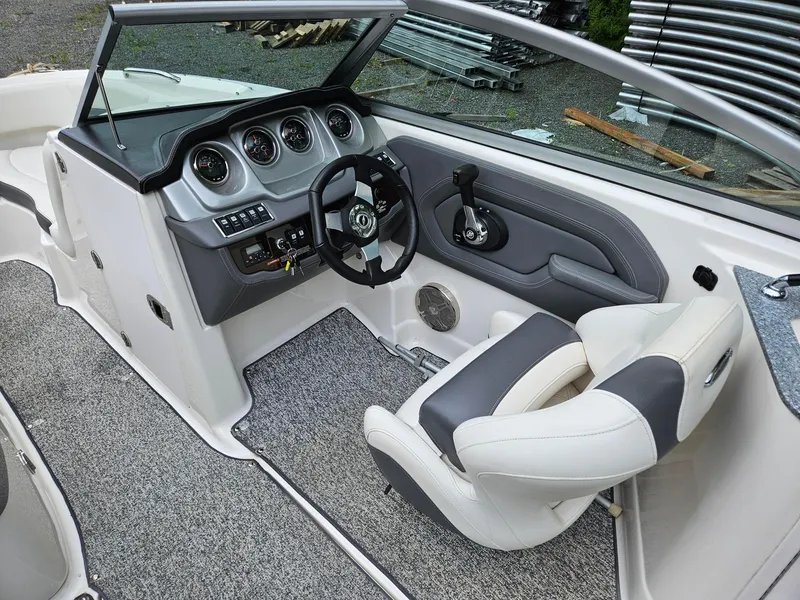 Slide: The Image of 2014 Chaparral 224 Sunesta boat interior with steering wheel and dashboard controls. - 12