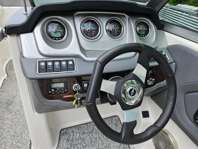 Slide: The Image of 2014 Chaparral 224 Sunesta dashboard with steering wheel and instrument panel. - 13