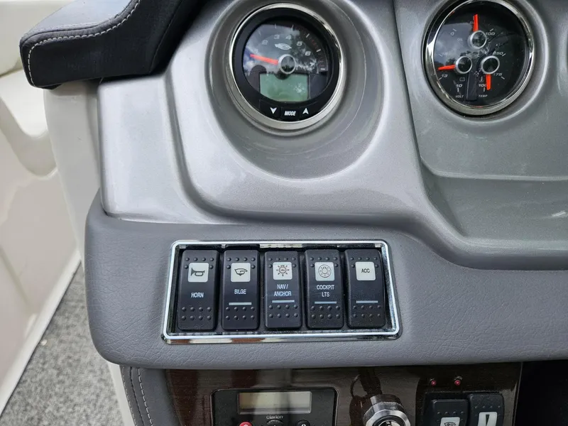 Slide: The Image of Dashboard controls of a 2014 Chaparral 224 Sunesta boat, featuring gauges and switches. - 15
