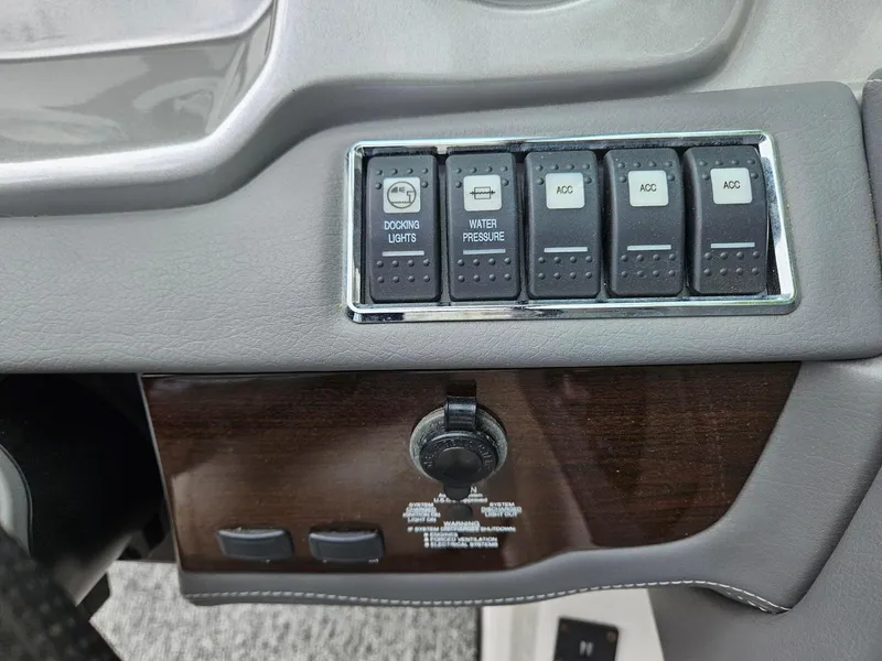 Slide: The Image of Control panel of a 2014 Chaparral 224 Sunesta boat with docking lights and accessory switches. - 16