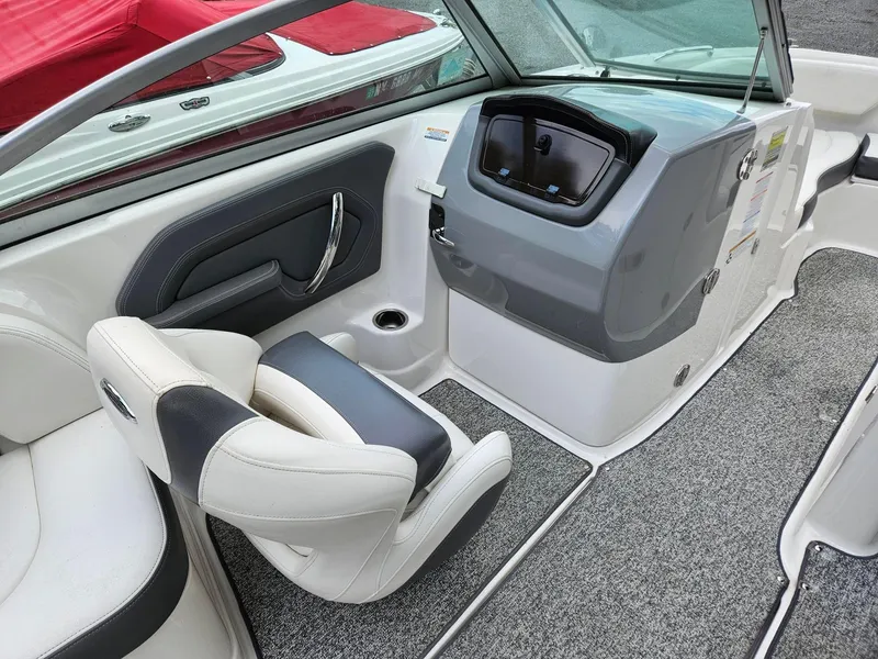 Slide: The Image of 2014 Chaparral 224 Sunesta boat interior with seating and dashboard. - 19
