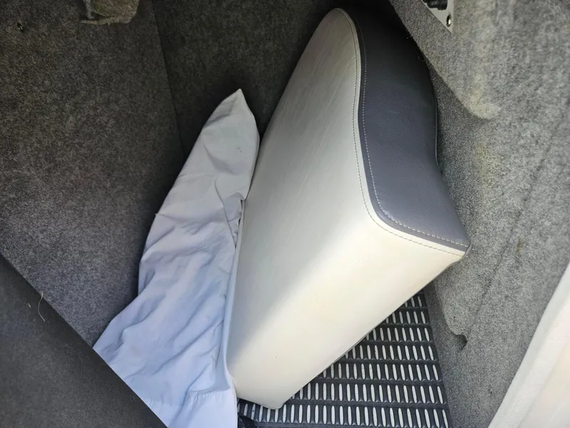 Slide: The Image of Cushion in a 2014 Chaparral 224 Sunesta boat interior, with gray upholstery and white fabric. - 23