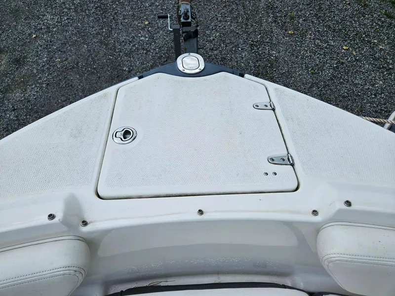 Slide: The Image of 2014 Chaparral 224 Sunesta boat deck with storage compartment and latch. - 24