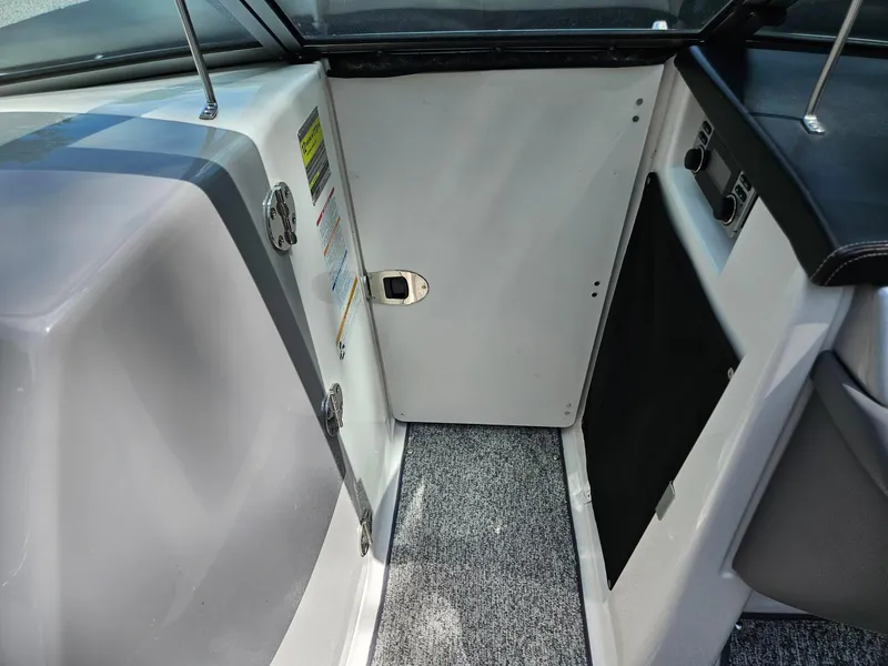 Slide: The Image of Interior view of a 2014 Chaparral 224 Sunesta boat, featuring a compact cabin area. - 29
