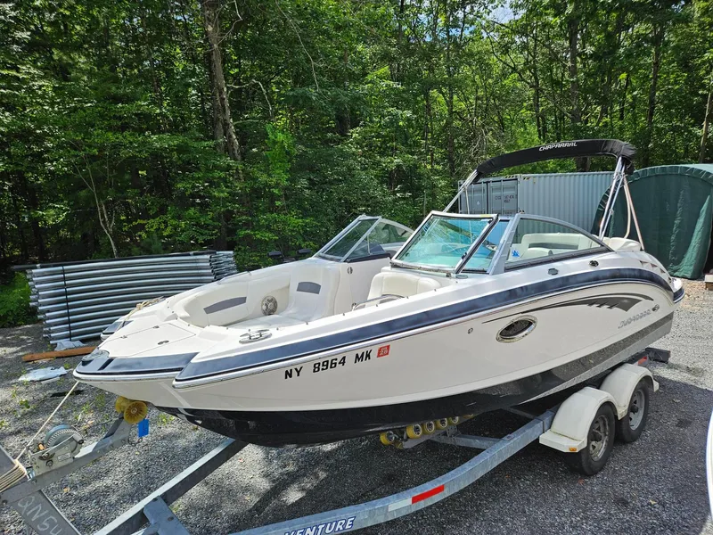 Slide: The Image of 2014 Chaparral 224 Sunesta boat on trailer in wooded area. - 3