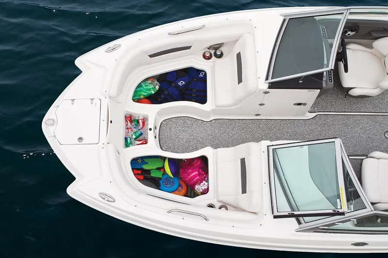 Slide: The Image of Manufacturer Provided Image: 2014 Chaparral 224 Sunesta boat with open storage compartments on the water. - 38