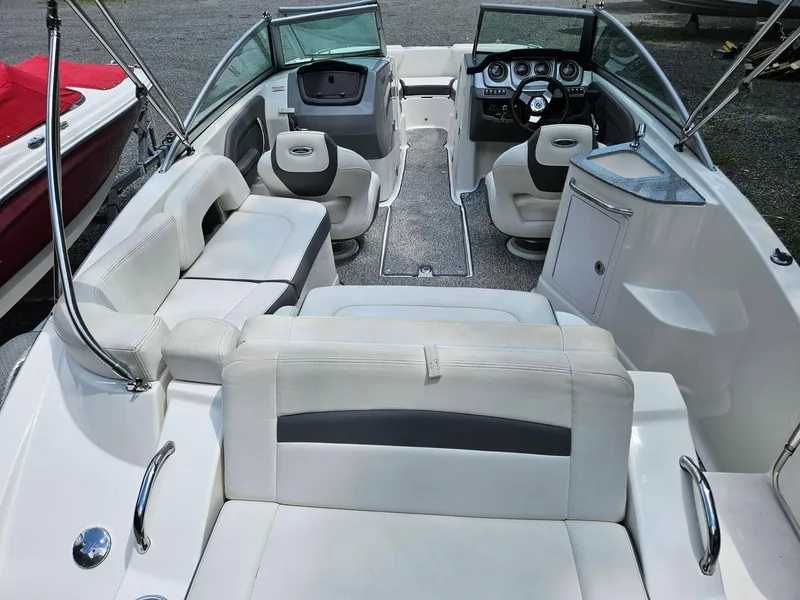 Slide: The Image of 2014 Chaparral 224 Sunesta boat interior with white seating and modern dashboard. - 5