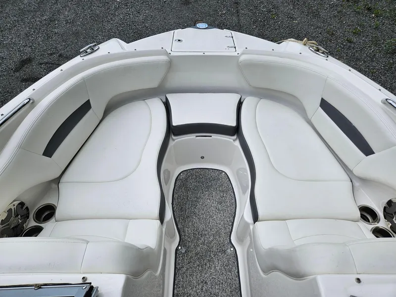 Slide: The Image of 2014 Chaparral 224 Sunesta boat interior with white seating and cup holders. - 6