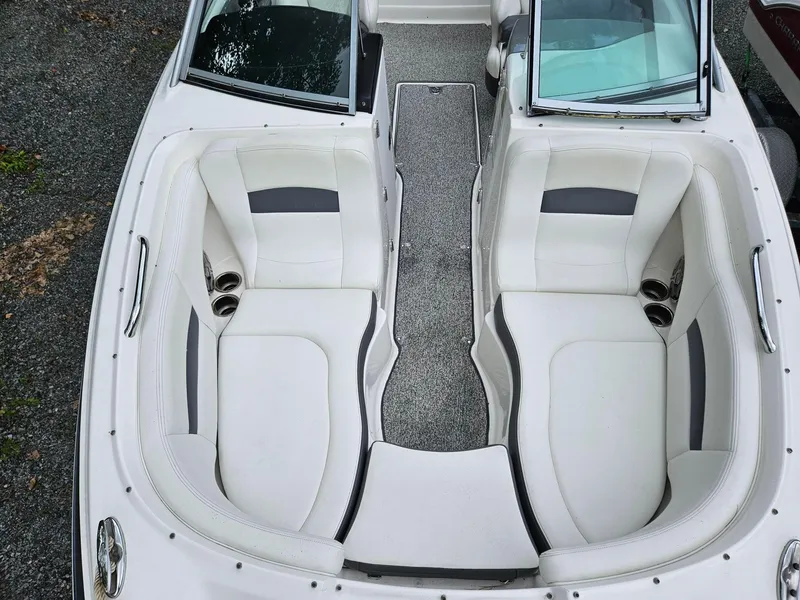 Slide: The Image of 2014 Chaparral 224 Sunesta boat interior with white seating and cup holders. - 8