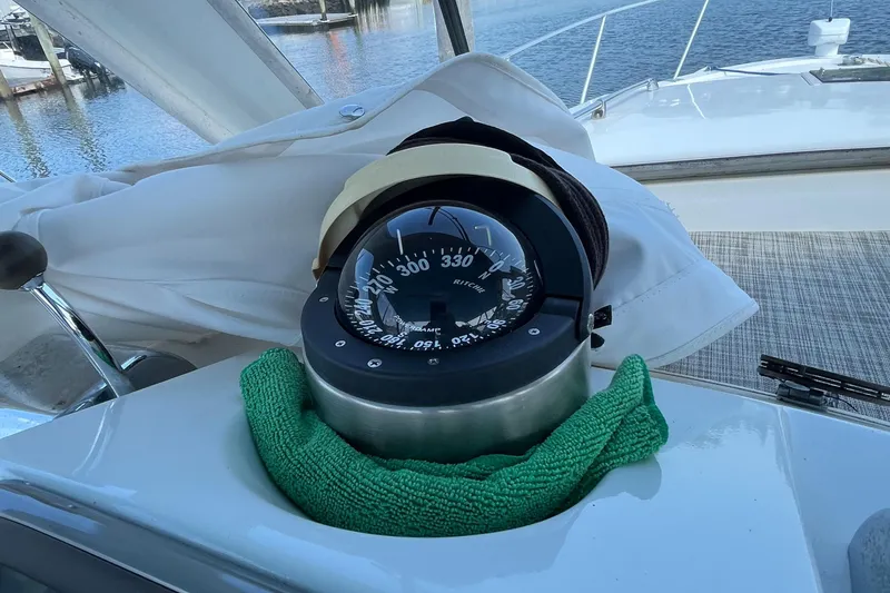 Slide: The Image of Compass on 1976 Uniflite 28 Salty Dog boat, docked by the water. - 12