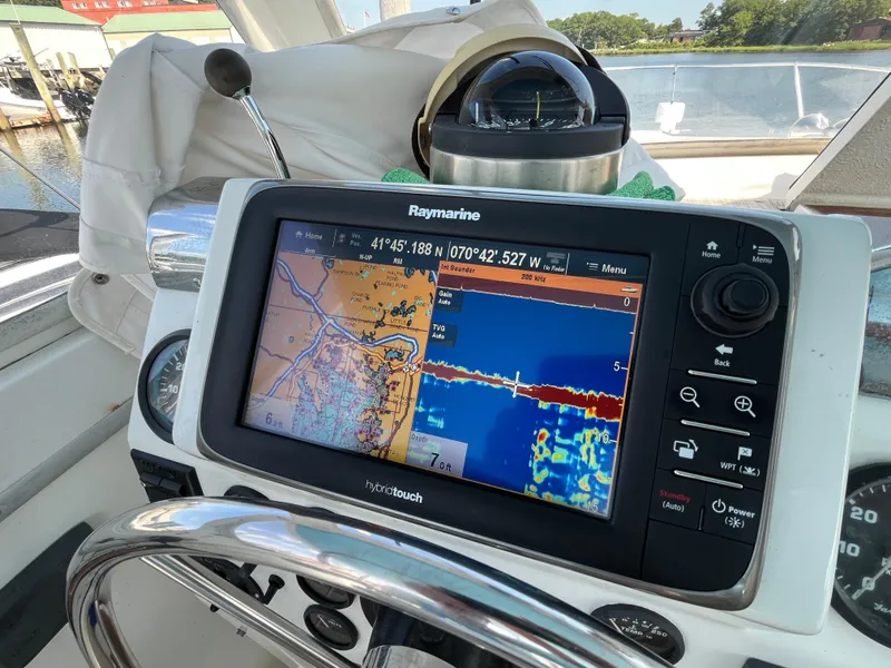 Slide: The Image of 1976 Uniflite 28 Salty Dog boat with Raymarine navigation system displaying nautical charts. - 13