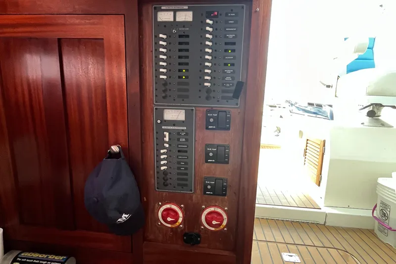 Slide: The Image of 1976 Uniflite 28 Salty Dog electrical panel with switches and gauges on wooden interior. - 17