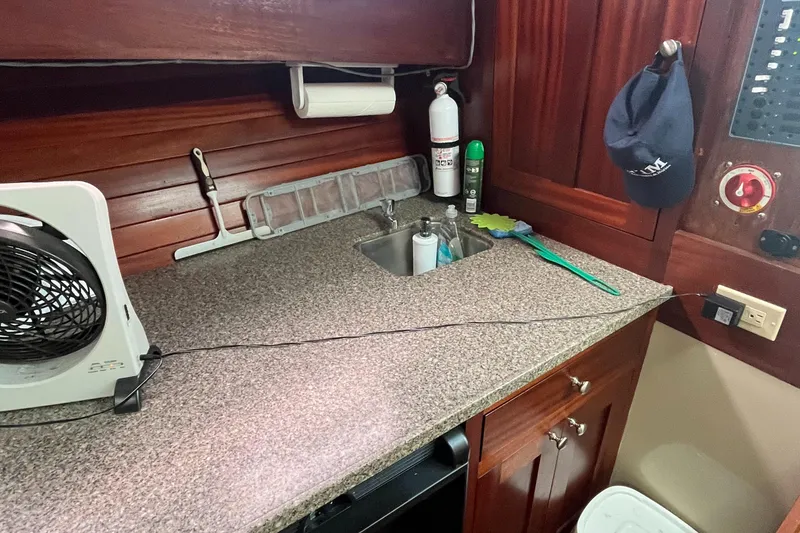 Slide: The Image of 1976 Uniflite 28 Salty Dog boat interior with countertop, sink, and fan. - 18