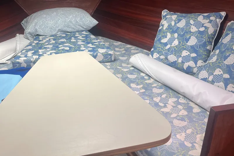 Slide: The Image of Interior of 1976 Uniflite 28 Salty Dog with blue fish-patterned bedding and wooden accents. - 20