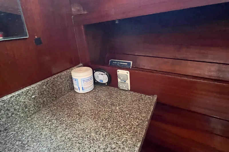 Slide: The Image of 1976 Uniflite 28 Salty Dog interior with granite countertop and wooden paneling. - 24