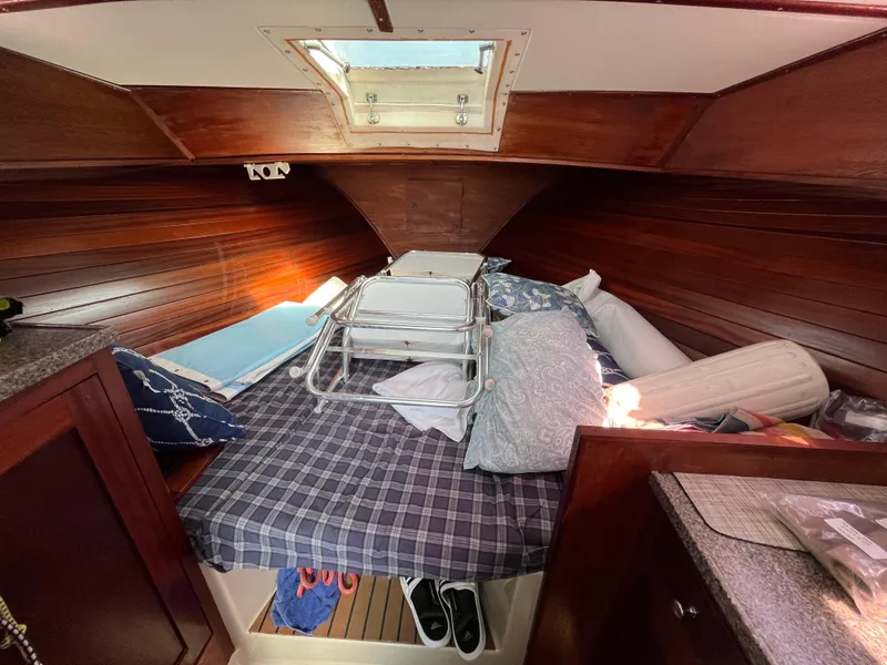 Slide: The Image of 1976 Uniflite 28 Salty Dog cabin interior with wooden paneling and bedding. - 25