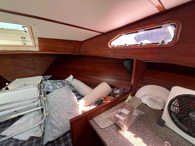 Slide: The Image of Interior of 1976 Uniflite 28 Salty Dog boat with wooden paneling and bedding. - 26