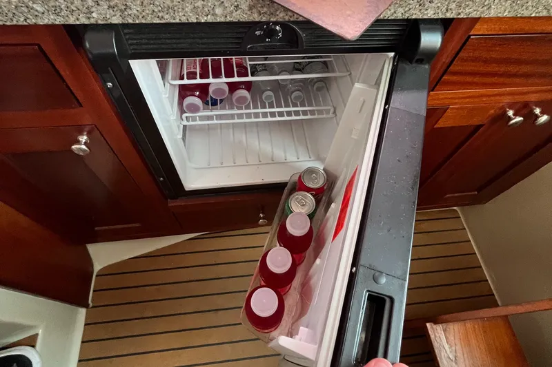 Slide: The Image of Open mini fridge on 1976 Uniflite 28 Salty Dog boat, stocked with drinks. - 27