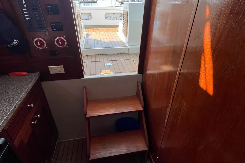 Slide: The Image of Interior view of a 1976 Uniflite 28 Salty Dog boat with wooden steps and control panel. - 28