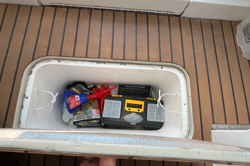 Slide: The Image of Storage compartment on 1976 Uniflite 28 Salty Dog boat with tools and equipment. - 29