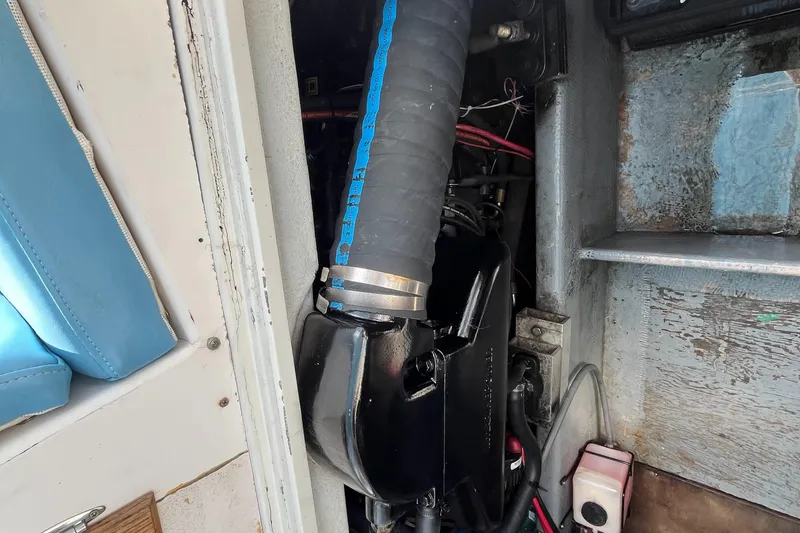 Slide: The Image of 1976 Uniflite 28 Salty Dog engine compartment with visible hoses and wiring. - 31