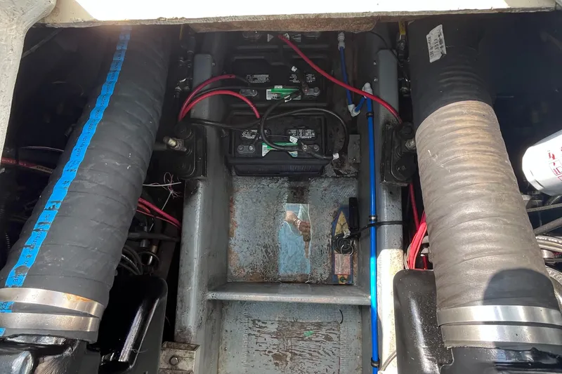 Slide: The Image of Engine compartment of a 1976 Uniflite 28 Salty Dog boat, showing batteries and wiring. - 32