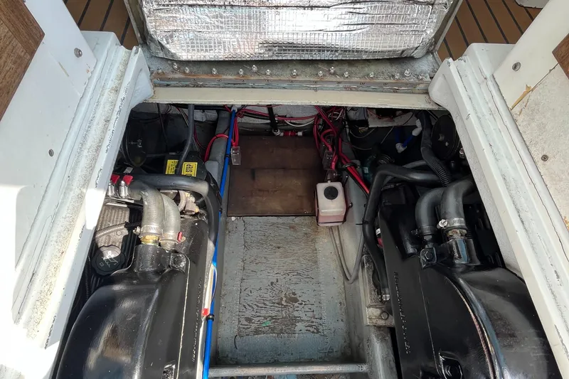 Slide: The Image of Engine compartment of a 1976 Uniflite 28 Salty Dog boat, showing mechanical components. - 33