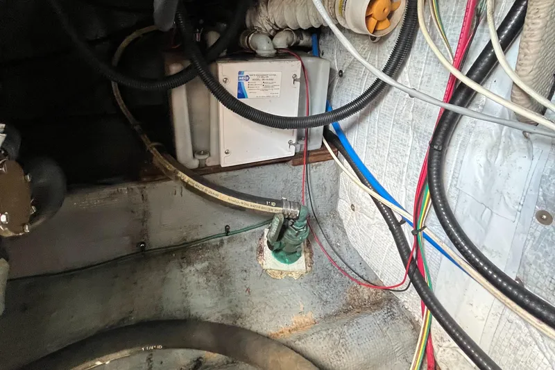 Slide: The Image of 1976 Uniflite 28 Salty Dog engine compartment with wiring and mechanical components. - 34