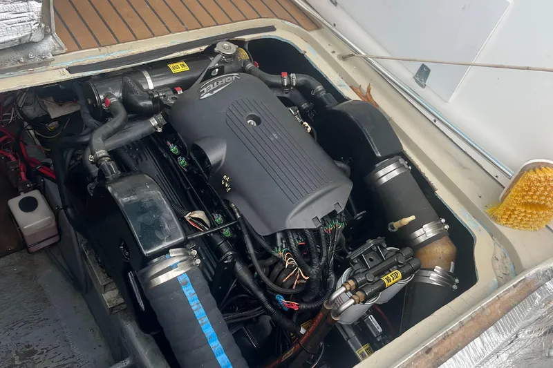 Slide: The Image of Engine compartment of a 1976 Uniflite 28 Salty Dog boat, showcasing detailed components. - 36