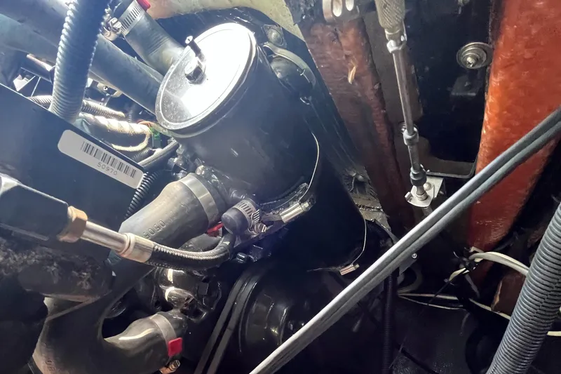 Slide: The Image of Engine compartment of a 1976 Uniflite 28 Salty Dog boat, showing hoses and components. - 39