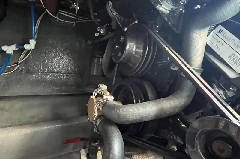 Slide: The Image of Engine compartment of a 1976 Uniflite 28 Salty Dog boat, showing hoses and pulleys. - 40