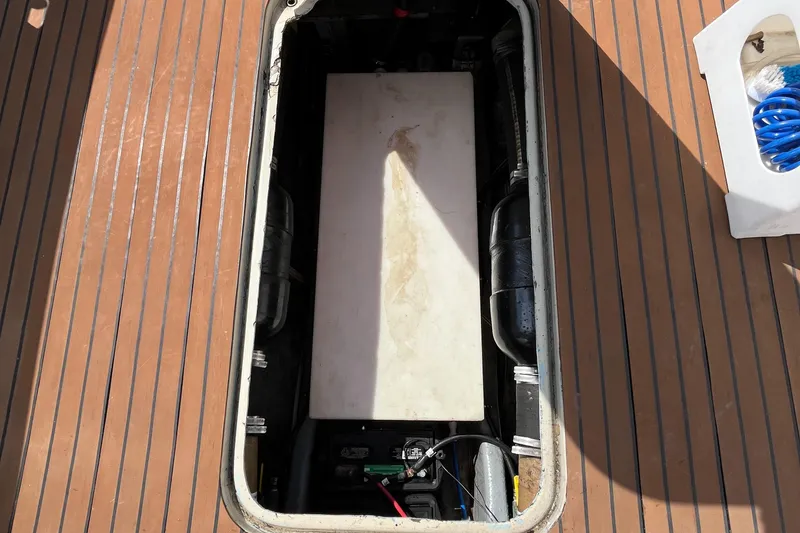 Slide: The Image of Open engine compartment of a 1976 Uniflite 28 Salty Dog boat, showing internal components. - 43